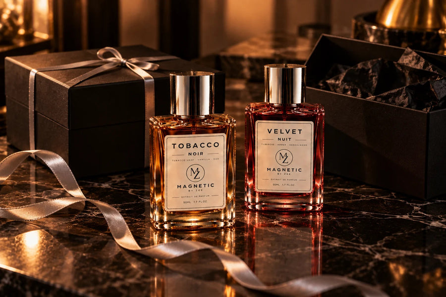 TOBACCO NOIR and VELVET NUIT with a black gift box, satin ribbon and an open gift box on dark marble