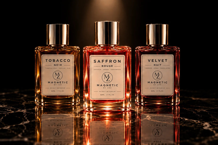 The three MAGNETIC BY ZEE scents, TOBACCO NOIR, SAFFRON ROUGE and VELVET NUIT, lined up on black marble