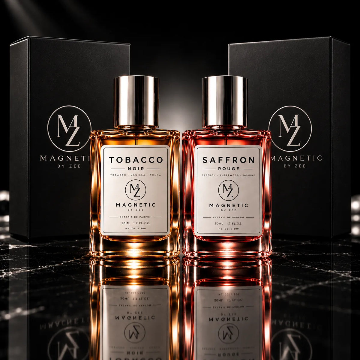 Two MAGNETIC BY ZEE bottles, TOBACCO NOIR and SAFFRON ROUGE, in front of their black signature gift boxes