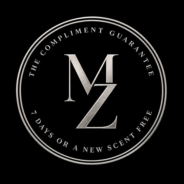 The Compliment Guarantee seal: silver MZ monogram reading 7 days or a new scent free