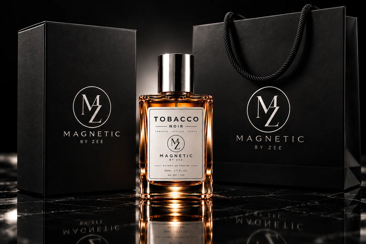 TOBACCO NOIR bottle between the black MAGNETIC BY ZEE gift box and black rope-handle shopping bag with silver monogram